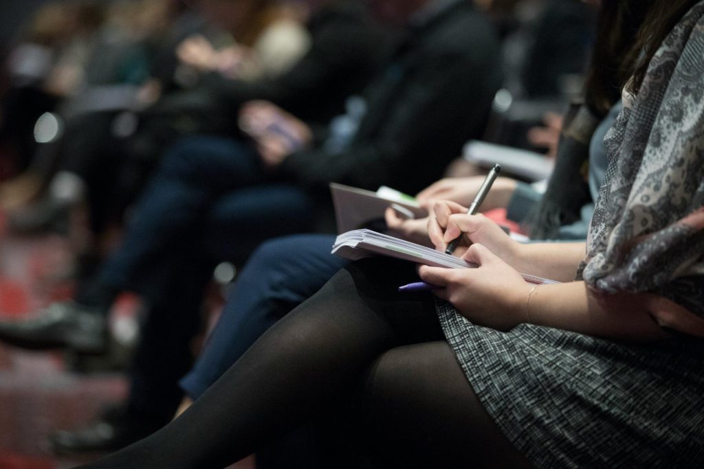 People taking notes in a profesisonal setting