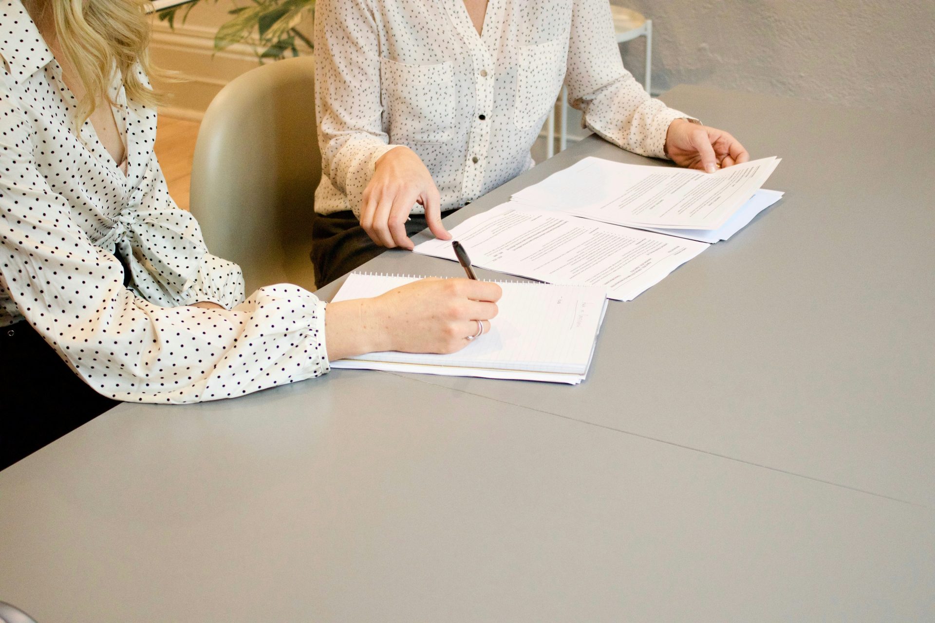 2 professional ladies signing documents